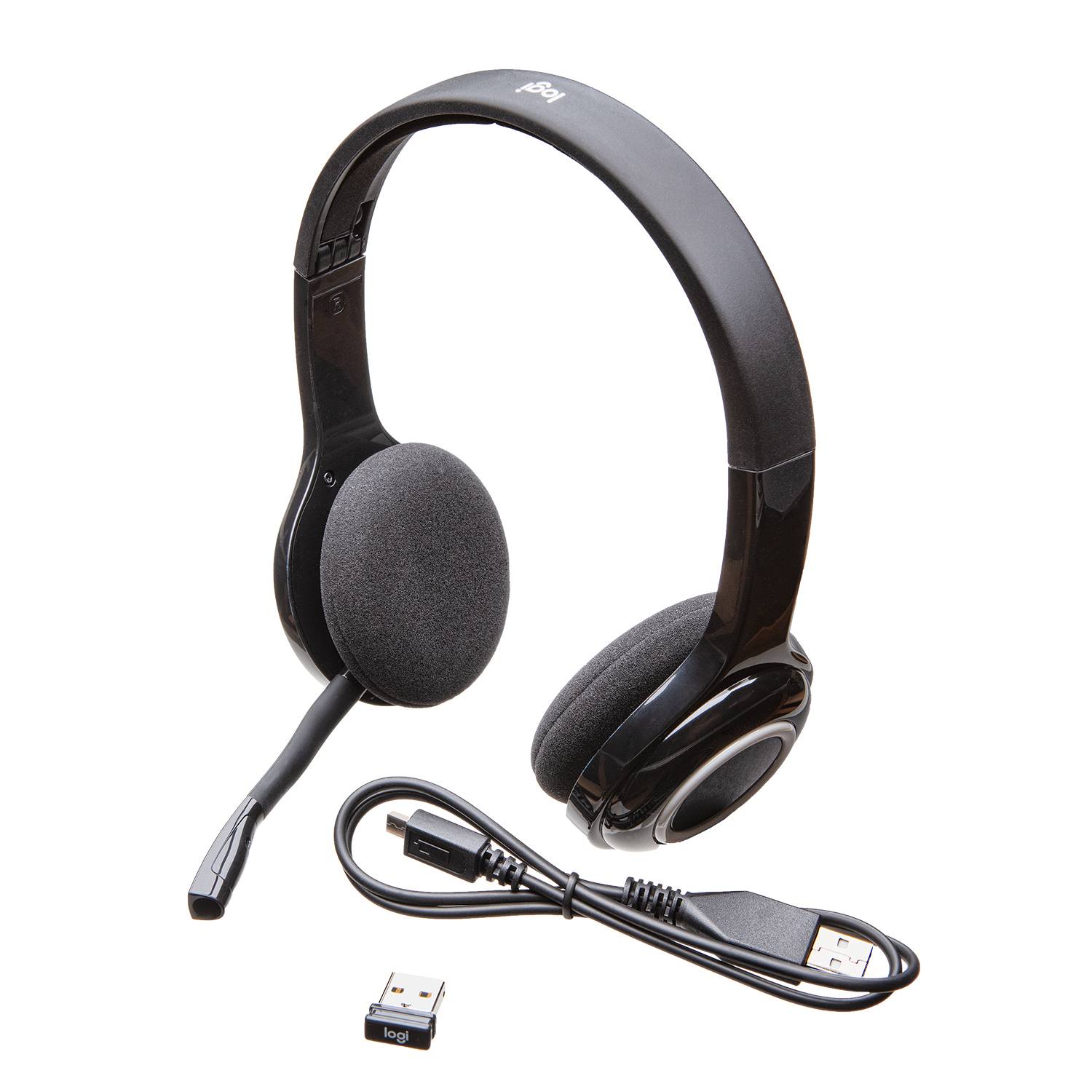 Black USB headset with adjustable microphone and soft ear cushions, USB cable and USB receiver placed beside it on white background.