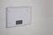 Heating panel mounted on a textured wall.