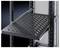 A black, perforated metal shelf in a server rack, pull-out for easy access and ventilation of equipment.