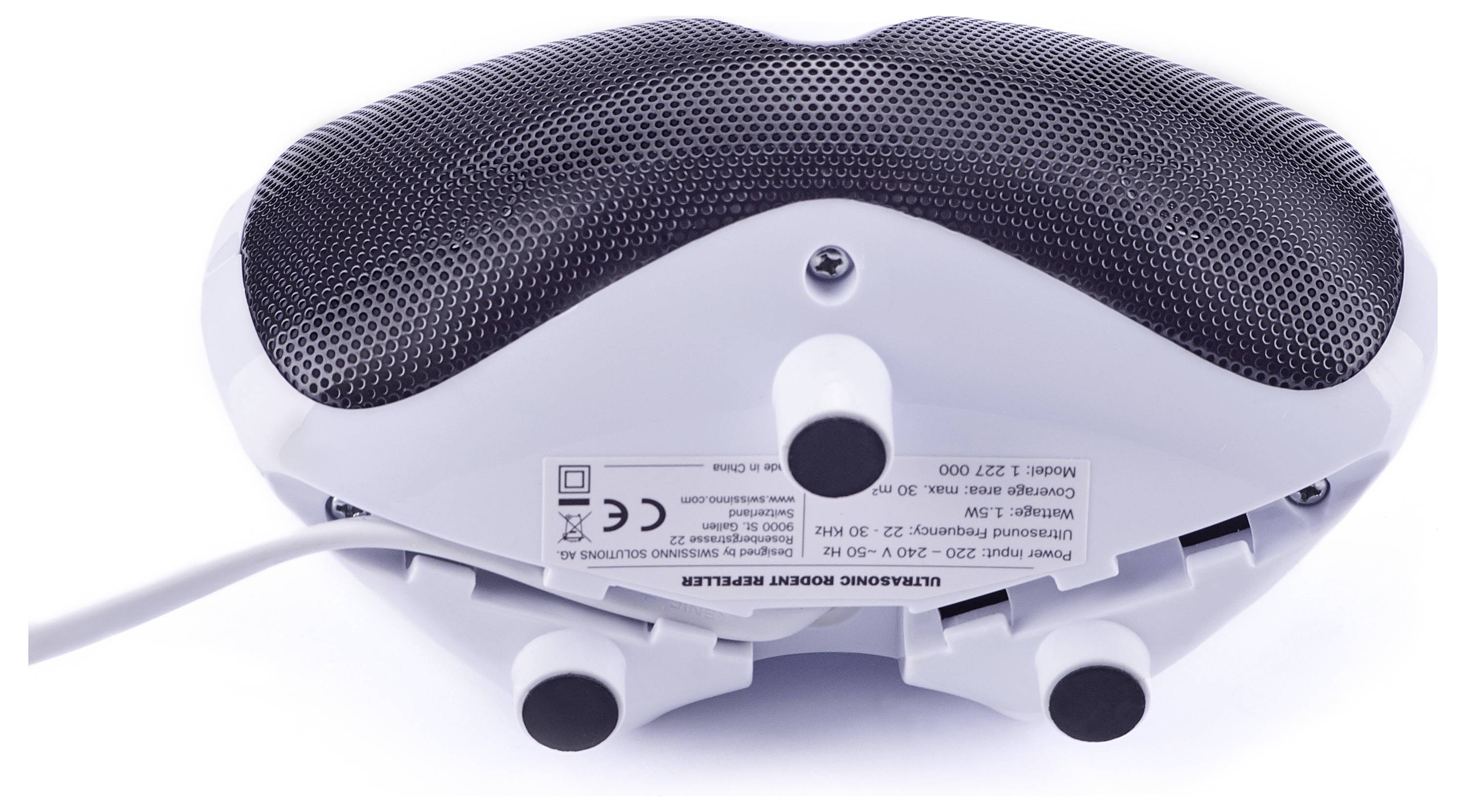 A white massage device with a textured black cushion, showing a label with specifications underneath, resting on a white surface.
