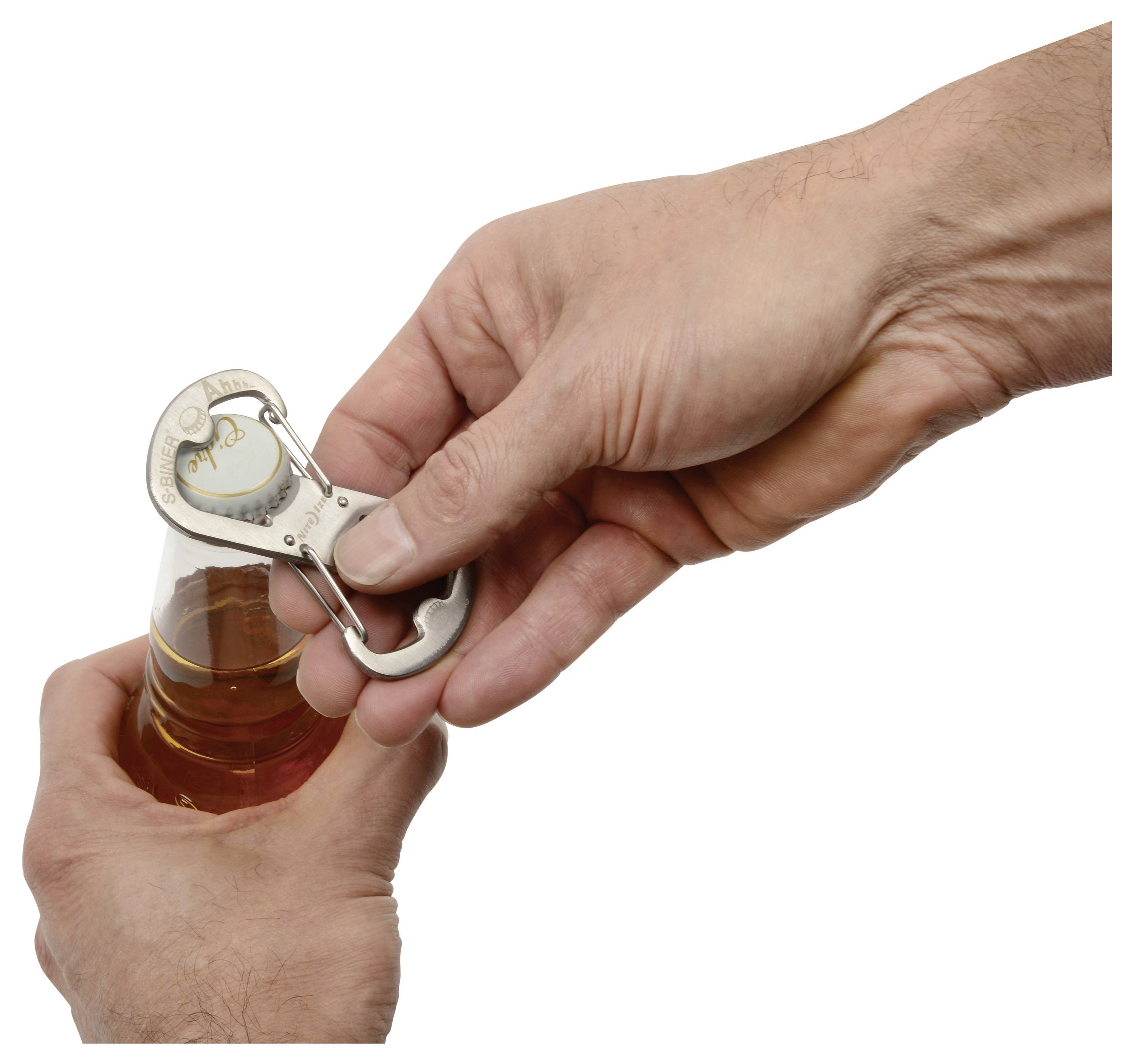 Two hands opening a bottle with a metal bottle opener. The left hand holds the bottle while the right hand uses the opener on the cap.