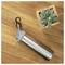 A stainless steel water bottle with a carabiner lies on a wooden table beside a small potted succulent.