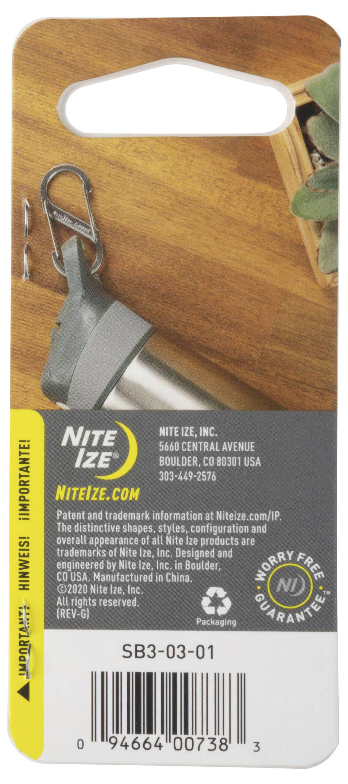 A product packaging with a carabiner and keychain accessory shown. Text includes 'Nite Ize' with address and patent information.