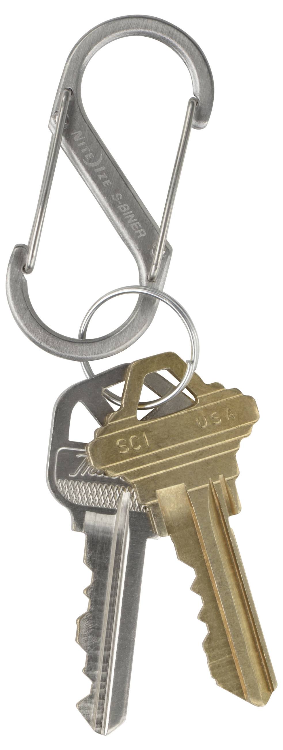 Three metal keys on a silver carabiner keyring, against a white background.