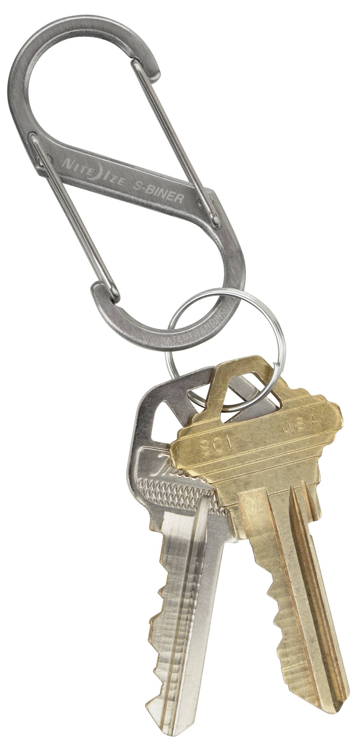 A metal carabiner holding three keys: a silver key and two brass keys, representing a simple keychain setup for securing keys.