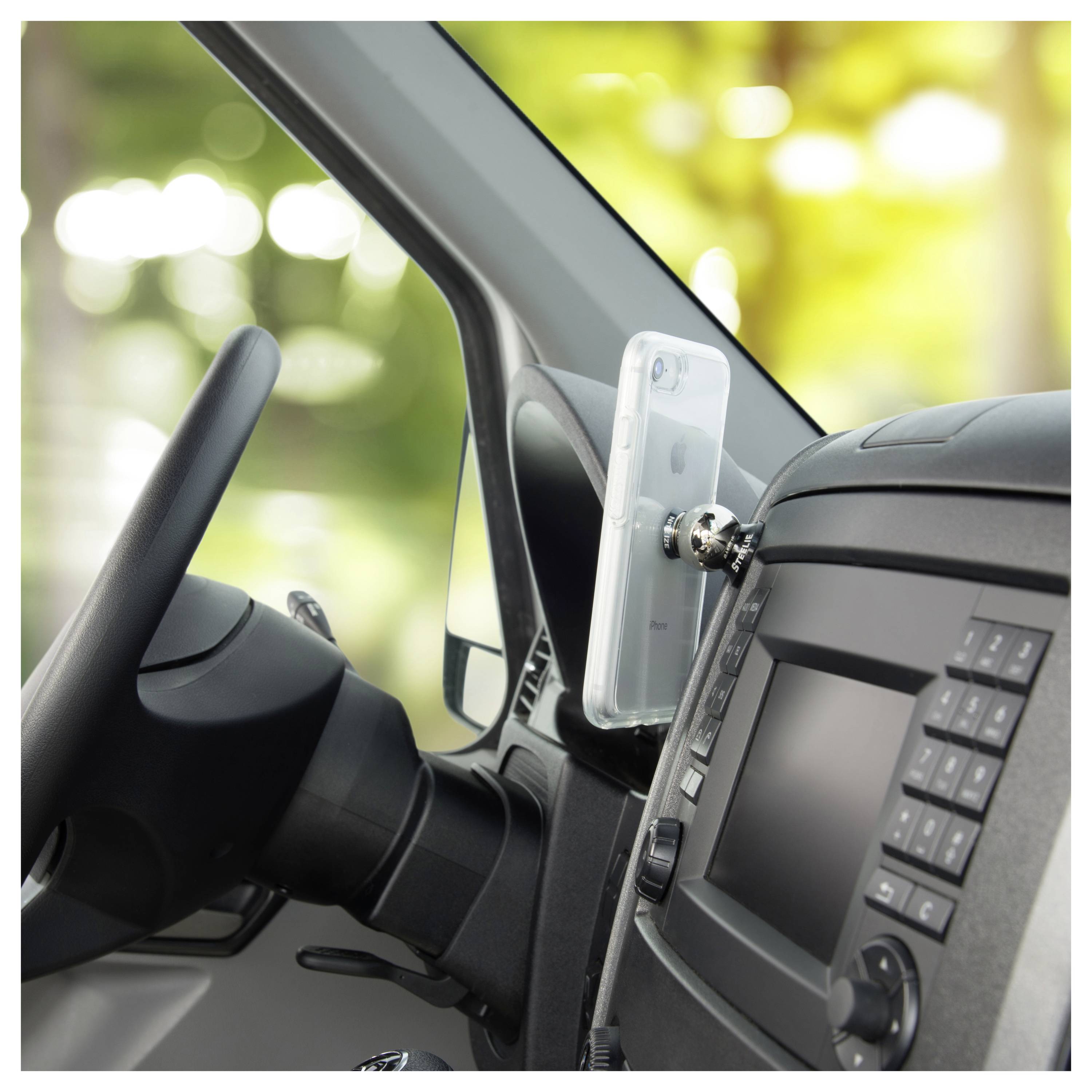 Phone mounted inside car on dashboard, displaying navigation screen.