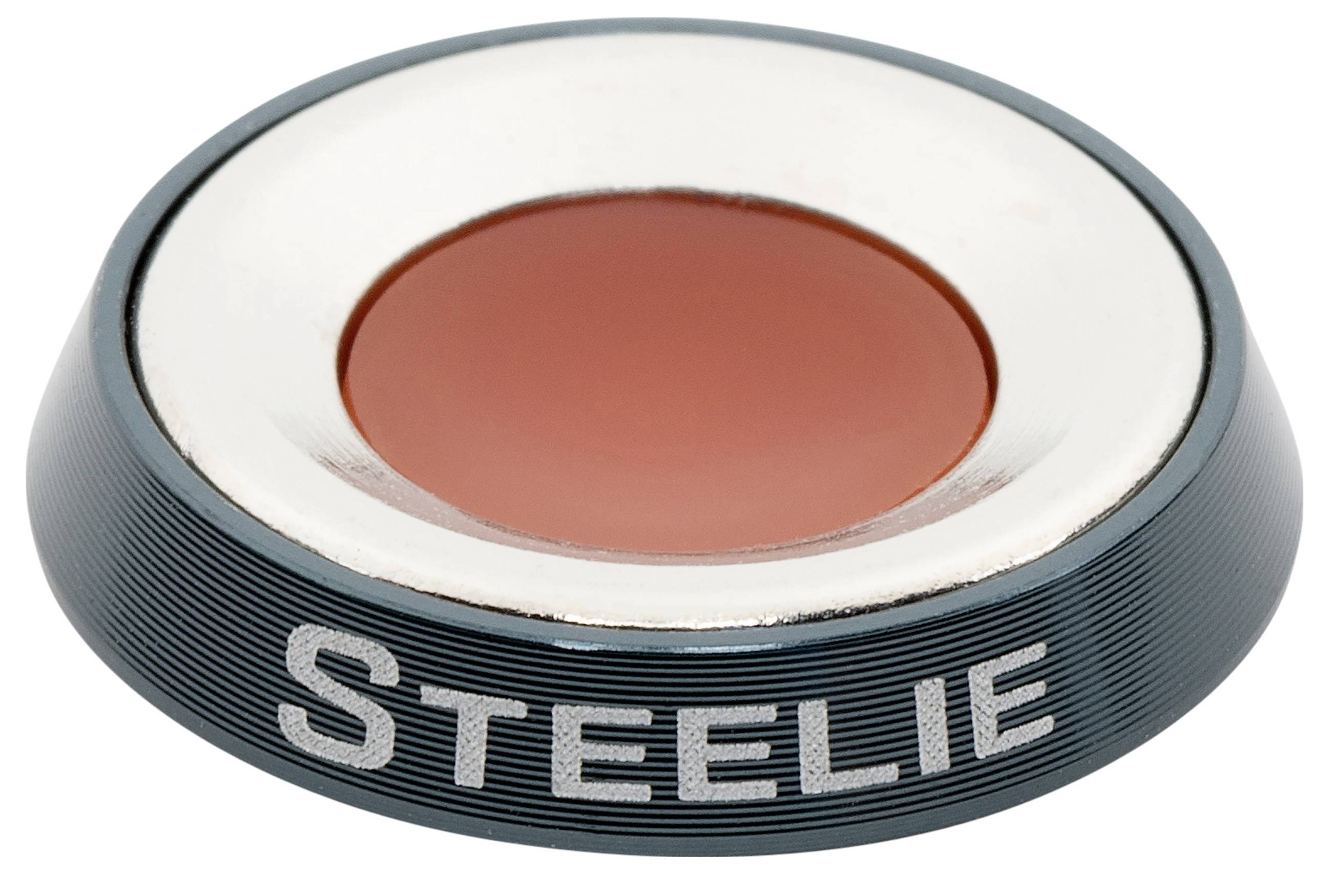 A magnetic phone mount disc with the word 'Steelie' engraved on its side; features a central red area and metallic rim.