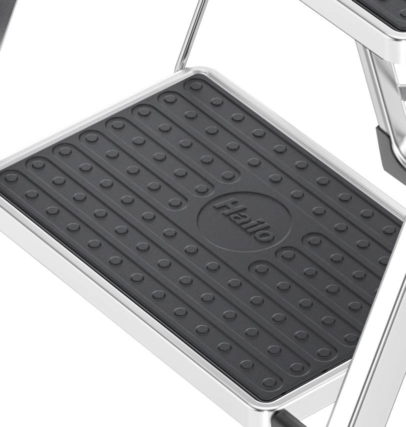Close-up of a black, non-slip step of a silver ladder. The brand name 'Hailo' is visible on the surface.