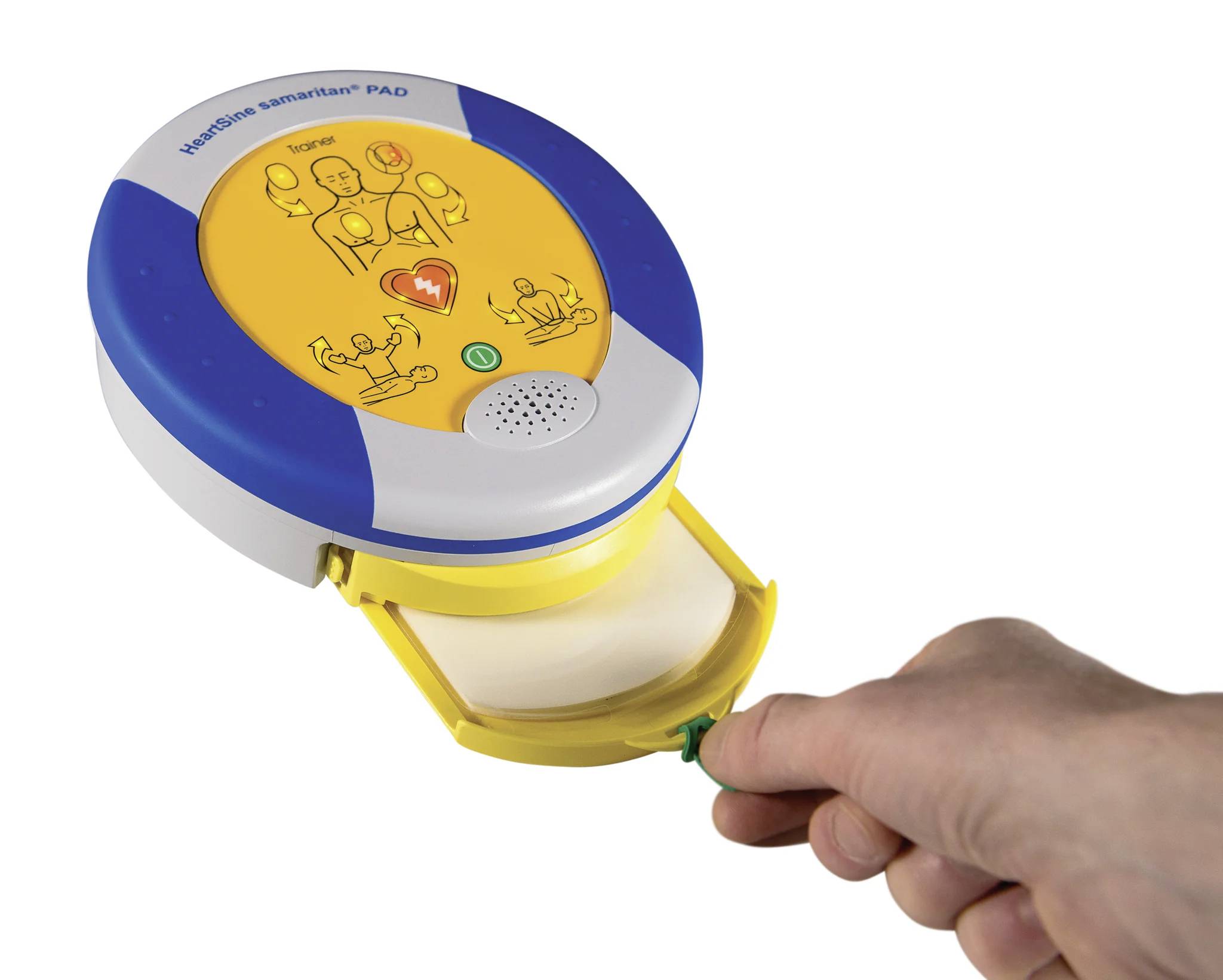 Portable defibrillator in blue and yellow colours. One hand is holding a tab on the device. Application pictograms are printed on it.