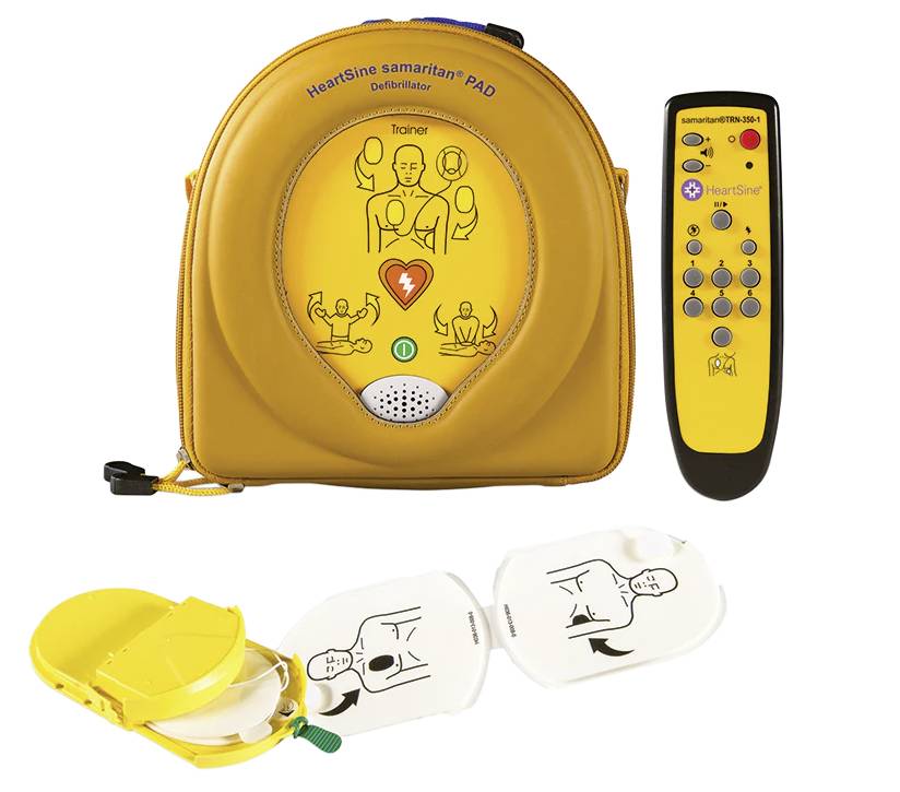 A defibrillator (HeartSine samaritan PAD) in a yellow bag with a trainer pad, showing instructions for cardiopulmonary resuscitation.