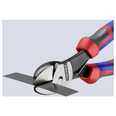 Close-up of a pair of red and blue-handled cutting pliers slicing through a strip of metal against a light gray background.