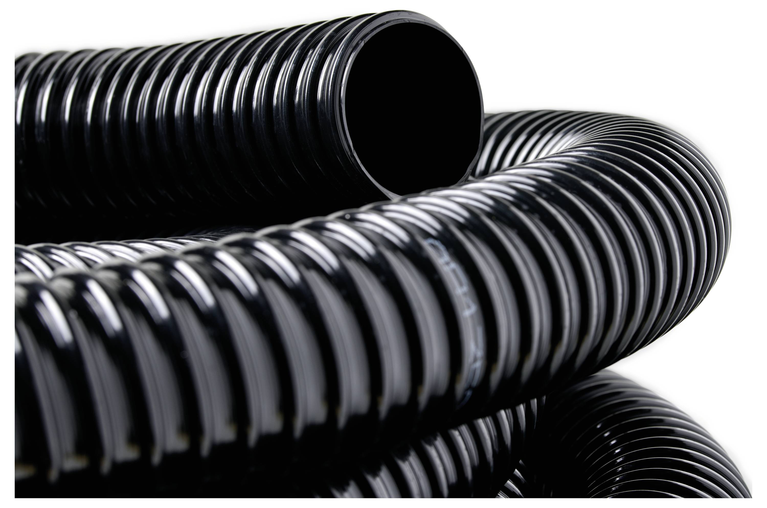 'Close-up of black corrugated plastic tubing coiled around itself, highlighting its texture and flexibility.'