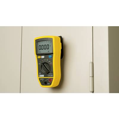 A yellow multimeter is attached to a grey cabinet. The display shows '0.000 V'. The device is in the OFF mode.