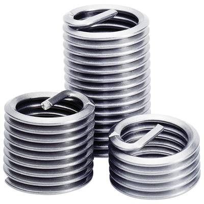 Three silver threaded inserts of different sizes stand upright. They are made of metal and have a spiral-shaped structure.