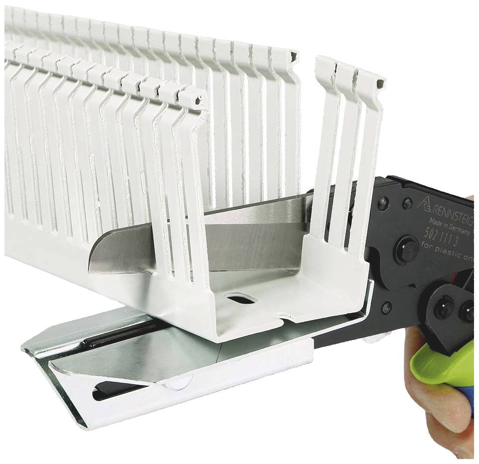 Tool for securing cable trunking covers. Person holding the device; white plastic covers are stacked.