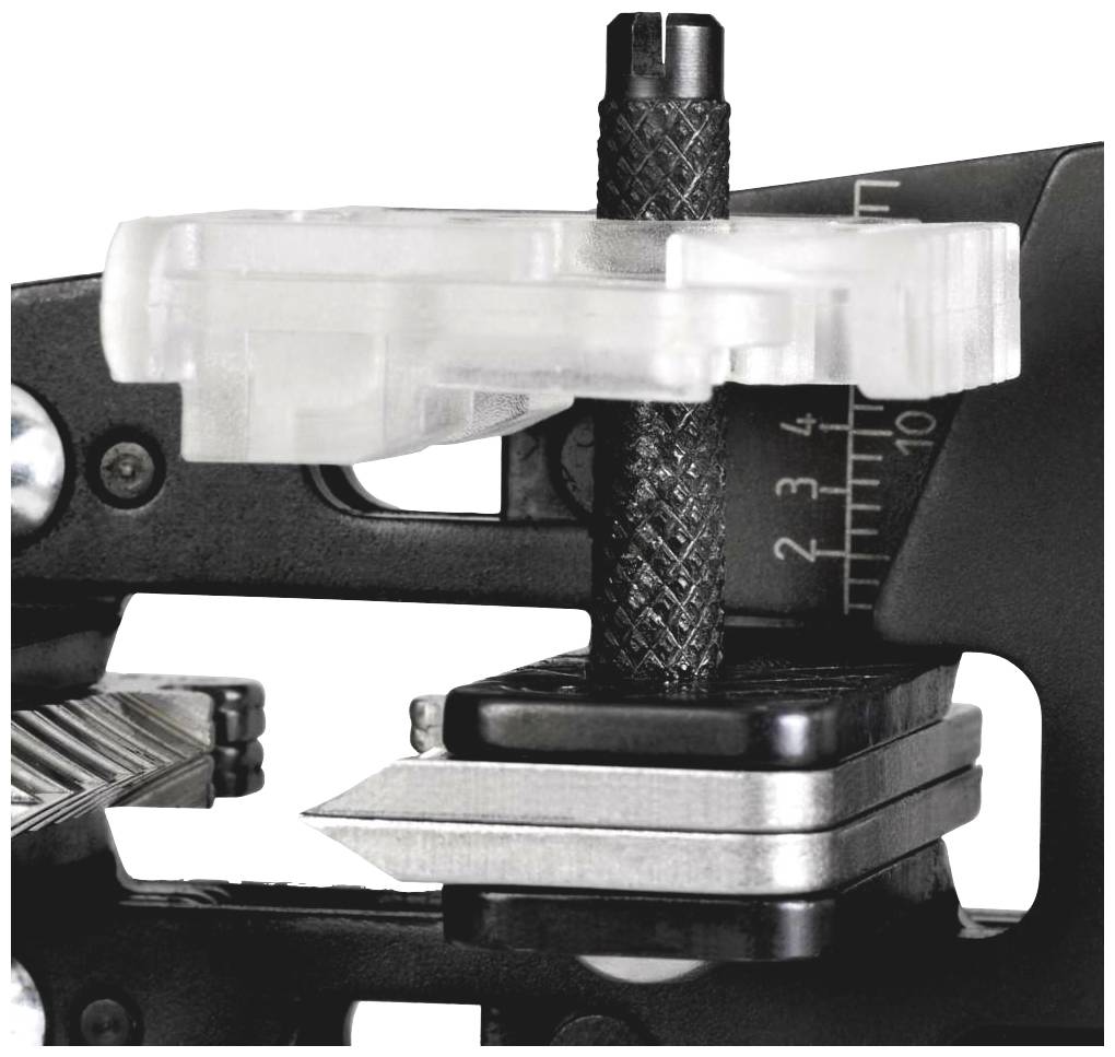 Device in close-up performing precision measurements on a black braided material. Scale in millimetres visible.