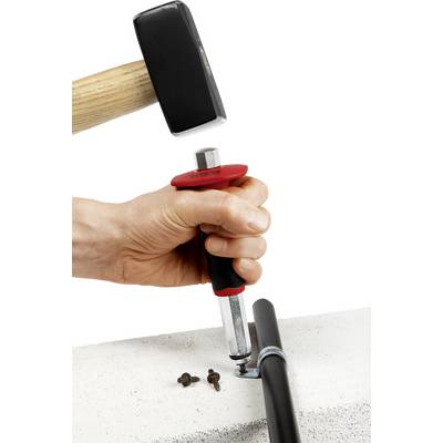 A hand is using a hammer and a tool to secure a screw to a metal pipe on a solid surface.