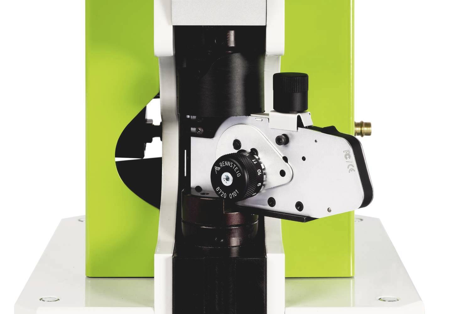 A microscope with a green casing and precise adjustment mechanism, used for detailed scientific investigations.
