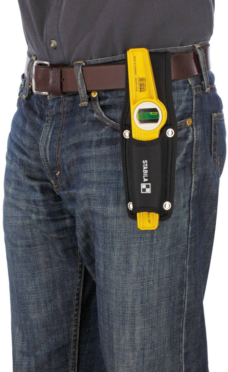 A person is wearing a spirit level holder on their belt, with a yellow spirit level inserted in it.
