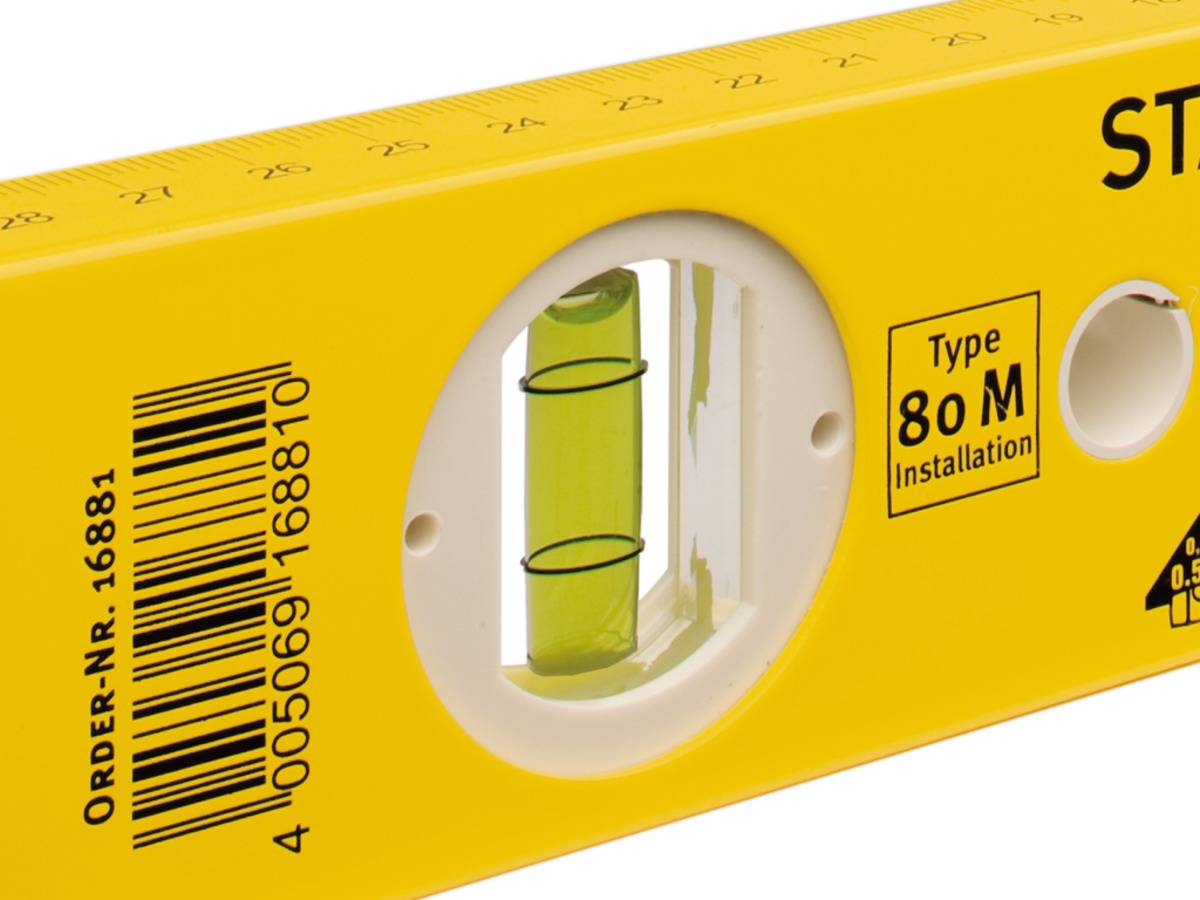 Yellow spirit level with a bubble vial for levelling. 'Type 80 M Installation' is written on it.