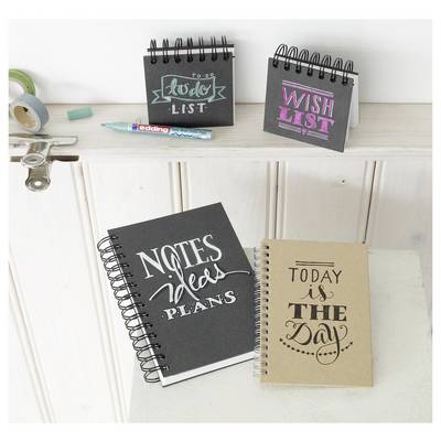Two small desk notepads on a shelf labeled 'today list' and 'wish list', with larger notebooks below reading 'notes ideas plans' and 'today is the day'.<br>