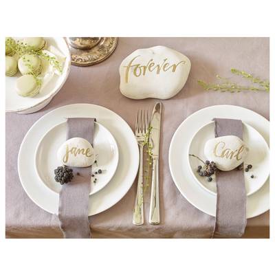 Elegant place settings for a wedding or celebration, with name cards reading 'forever', 'jane', and 'Carl' and macarons as table decor.