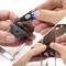 'Hands applying glue to a leather belt before attaching a metal buckle, showing the repair process.'