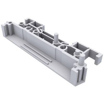 A grey, rectangular component with various recesses and protrusions, likely a technical or industrial part.