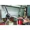 A person is operating an industrial drilling machine with a torque wrench to ensure precise settings and control.