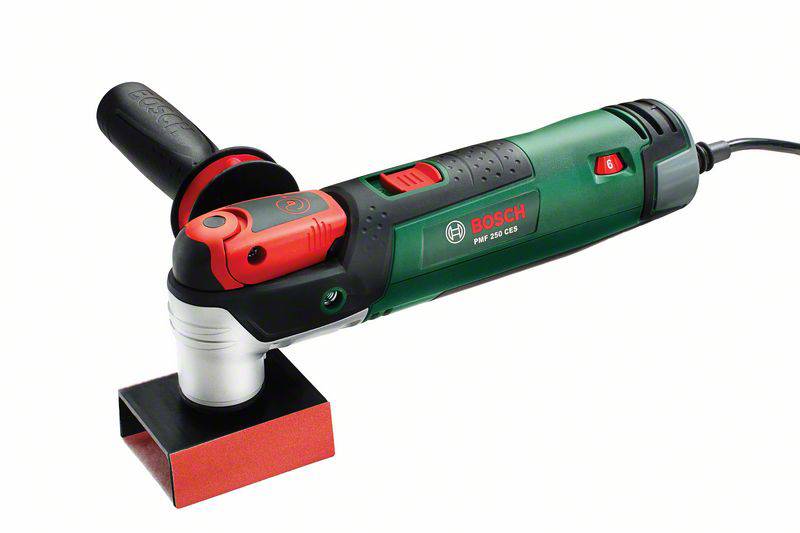 An electric angle grinder in green and red with a black handle and red switch.