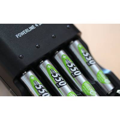A battery charger charges four AA batteries.