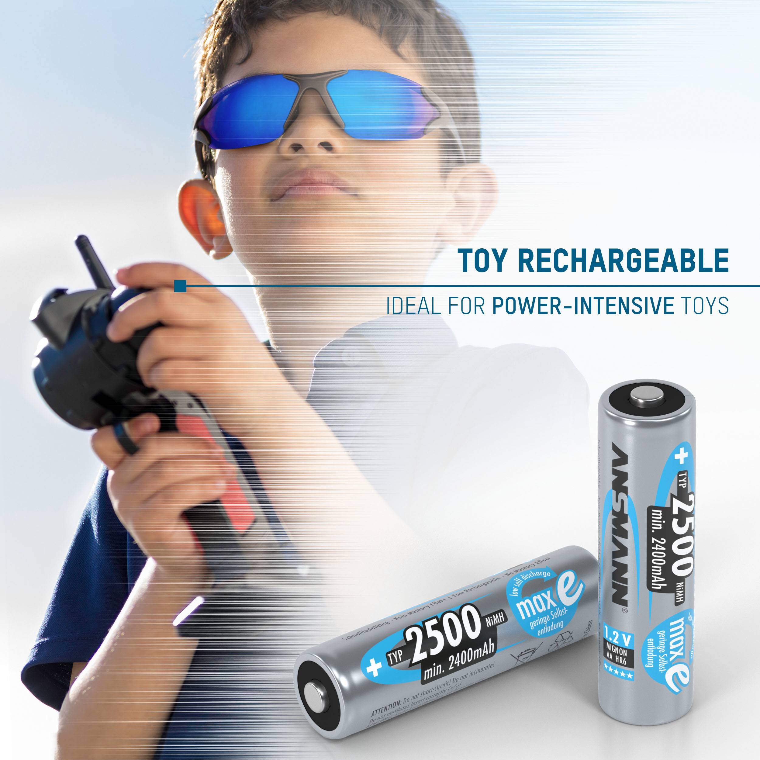A child wearing sunglasses is holding a remote control. In the foreground, two toy batteries '2500 mAh' for high-performance devices.