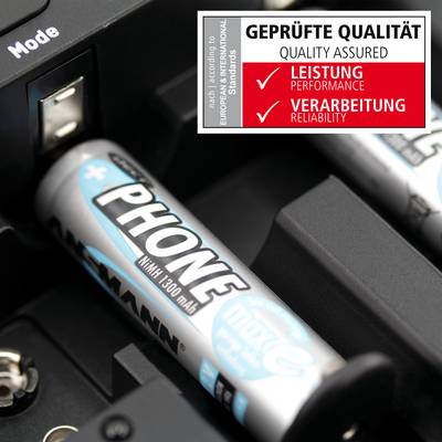 A close-up of a battery charger with batteries inserted. A label shows the words 'TESTED QUALITY' with categories 'Performance' and 'Workmanship'.