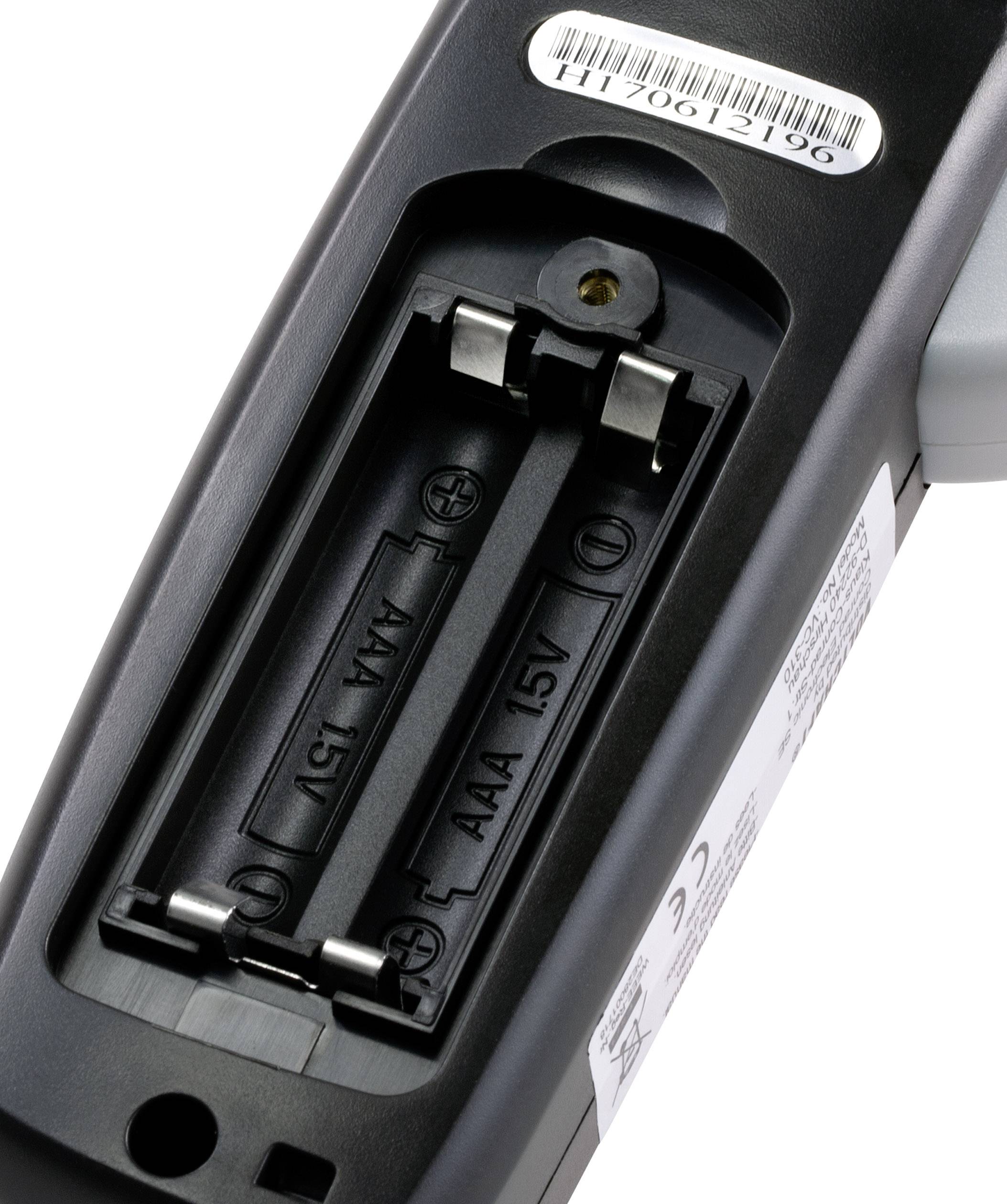 Remote control with open battery compartment, showing space for two AAA batteries. A barcode label is visible at the top.