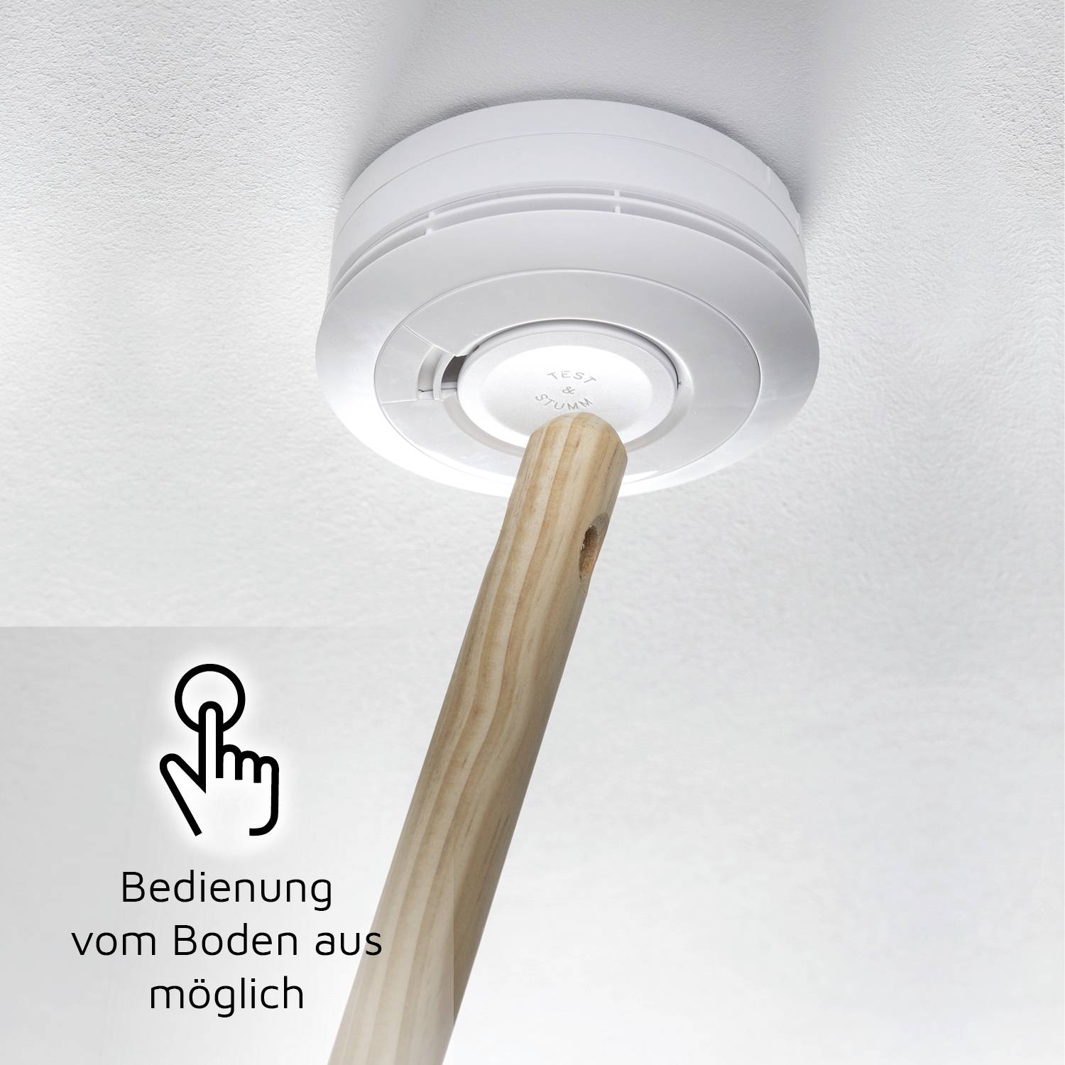 'Smoke detector on the ceiling in the living room with a long pole for operation from the floor.'