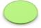A green glass filter in a circular shape, lying on a white surface.