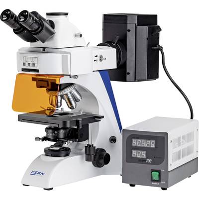 A microscope with multiple objective lenses and a digital display, connected to an external power supply.