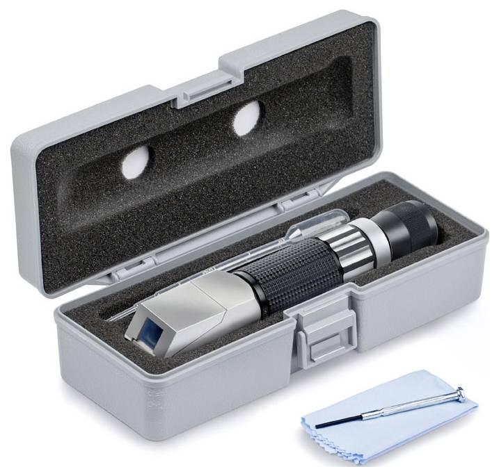 A portable refractometer in an opened, foam-filled case with cleaning accessories. Device for measuring liquid density.