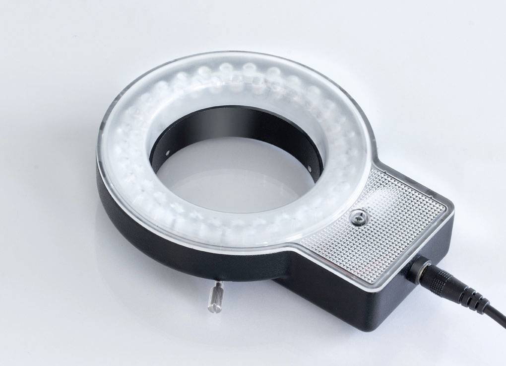 Camera ring light on a white background, with connecting cable. It is used to create uniform lighting when photographing.