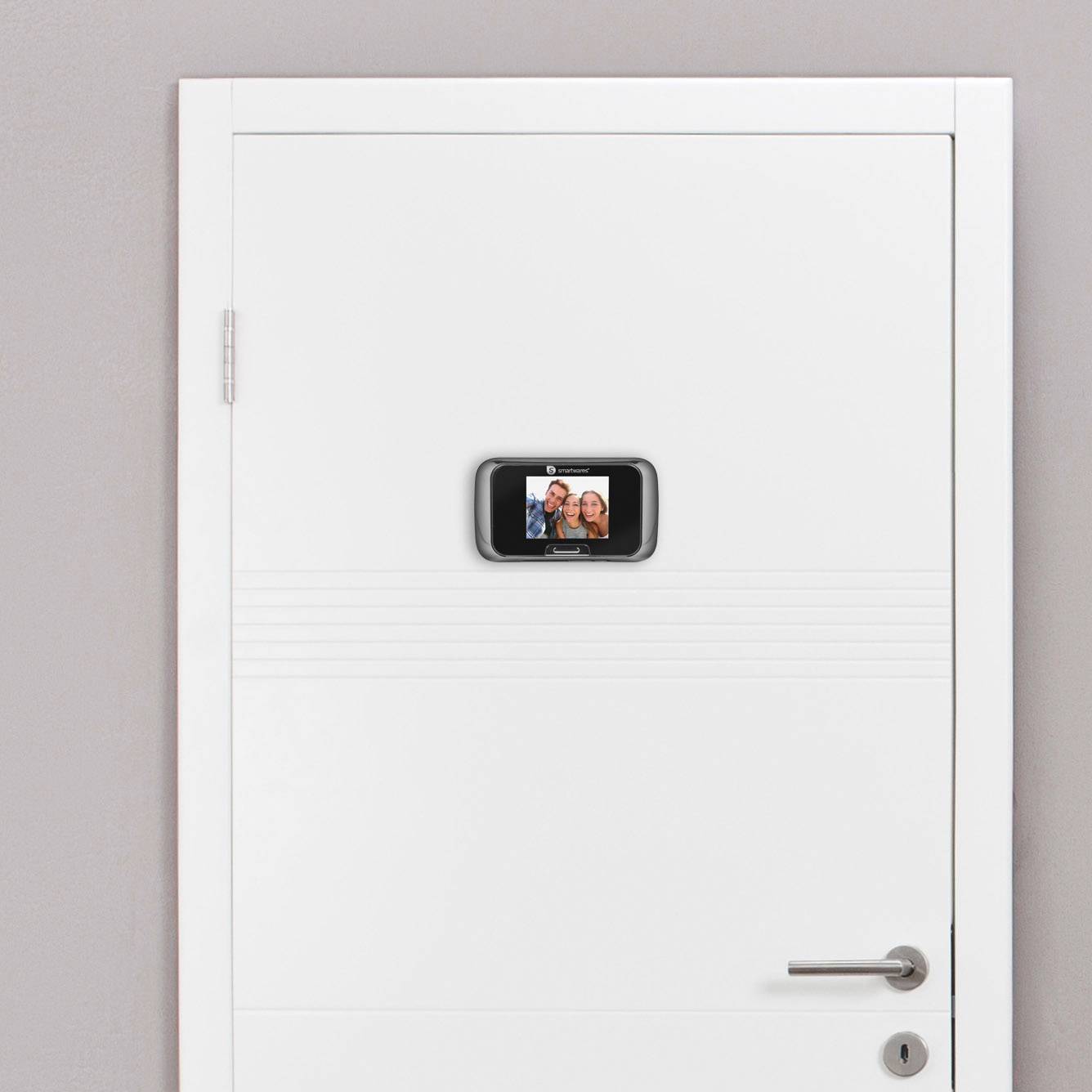 A white door with a digital door viewer displaying an image of two smiling people.