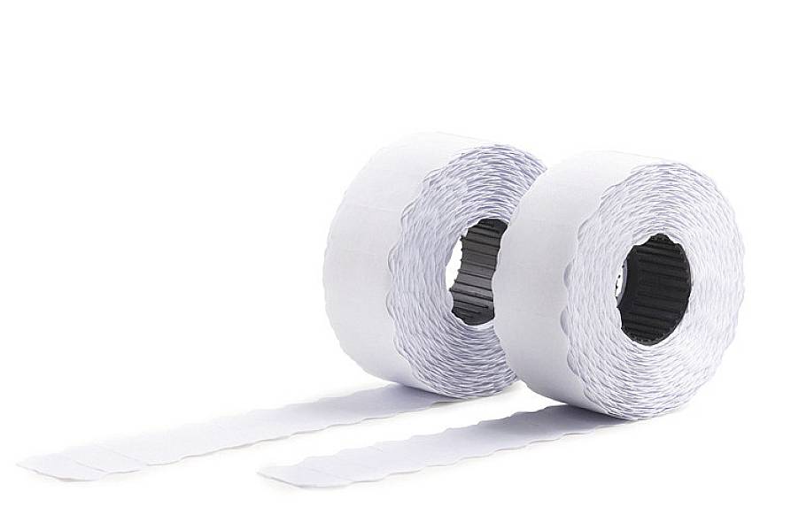 Two white rolls of paper side by side, with a piece of paper unrolled on a white surface.