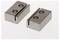 Two grey metal blocks with notches and holes on a white background.