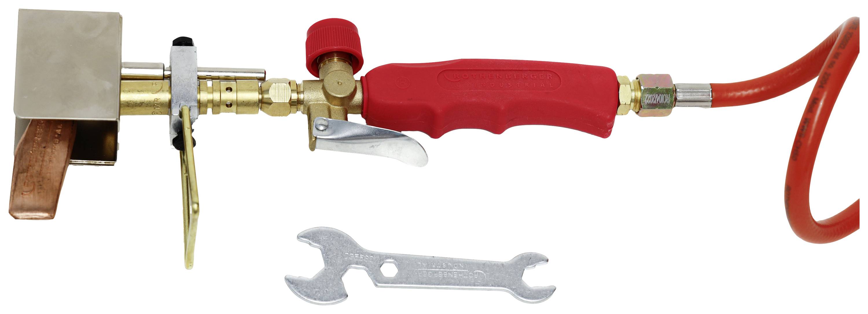 Soldering iron with red handle and gas connection, with a spanner lying beside it. Used for soldering metal parts.