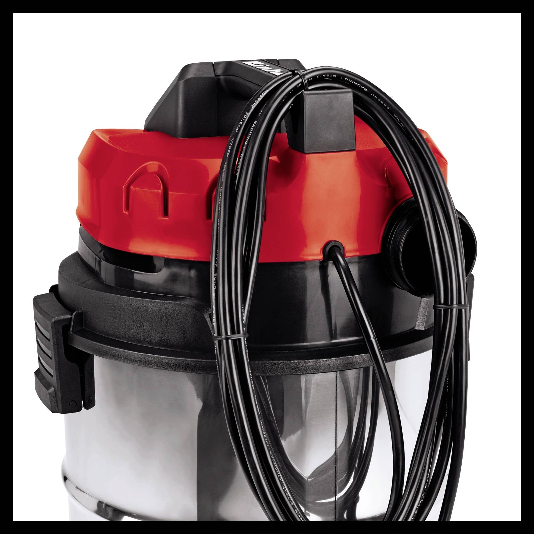 Vacuum cleaner in close-up, black and red, with cable coiled on top.