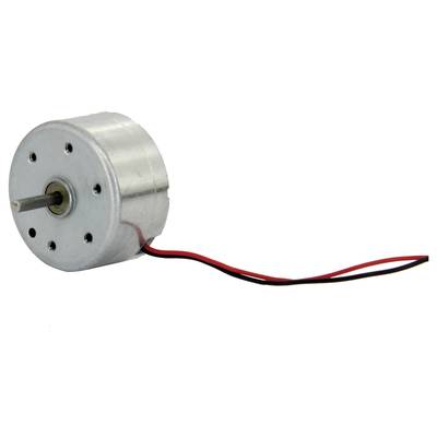 A small, round electric motor with a metal casing and two protruding, coloured cables is used for power supply in devices.