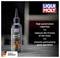 A bottle of LIQUI MOLY chain oil on a table. Text: 'Excellent corrosion protection. Noticeably reduces chain friction. Ensures exceptional running smoothness.' Made in Germany.