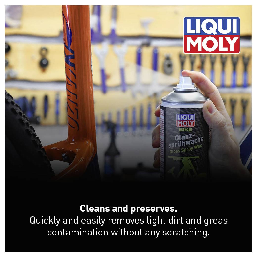 A person is spraying Liqui Moly gloss spray wax onto a bicycle. Text: Cleans and preserves, removes light dirt and greasy grime.