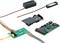 A kit of electronic components, including a green circuit board, speaker components, and connecting cables.