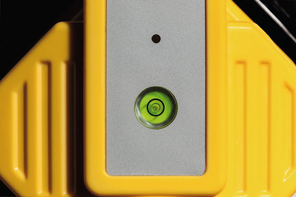 Spirit level with a green bubble on a yellow background, indicating precise alignment.