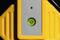 Spirit level with a green bubble on a yellow background, indicating precise alignment.